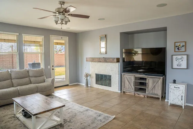 a living room with furniture a flat screen tv and a fireplace