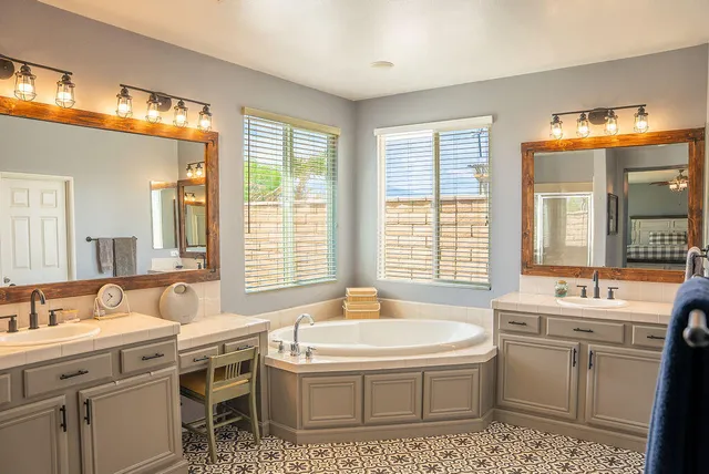 a bathroom with a tub sink and mirror