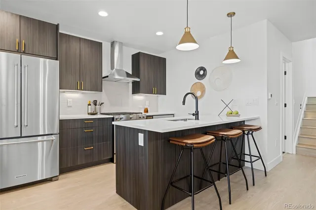 a kitchen with a refrigerator a sink and a stove