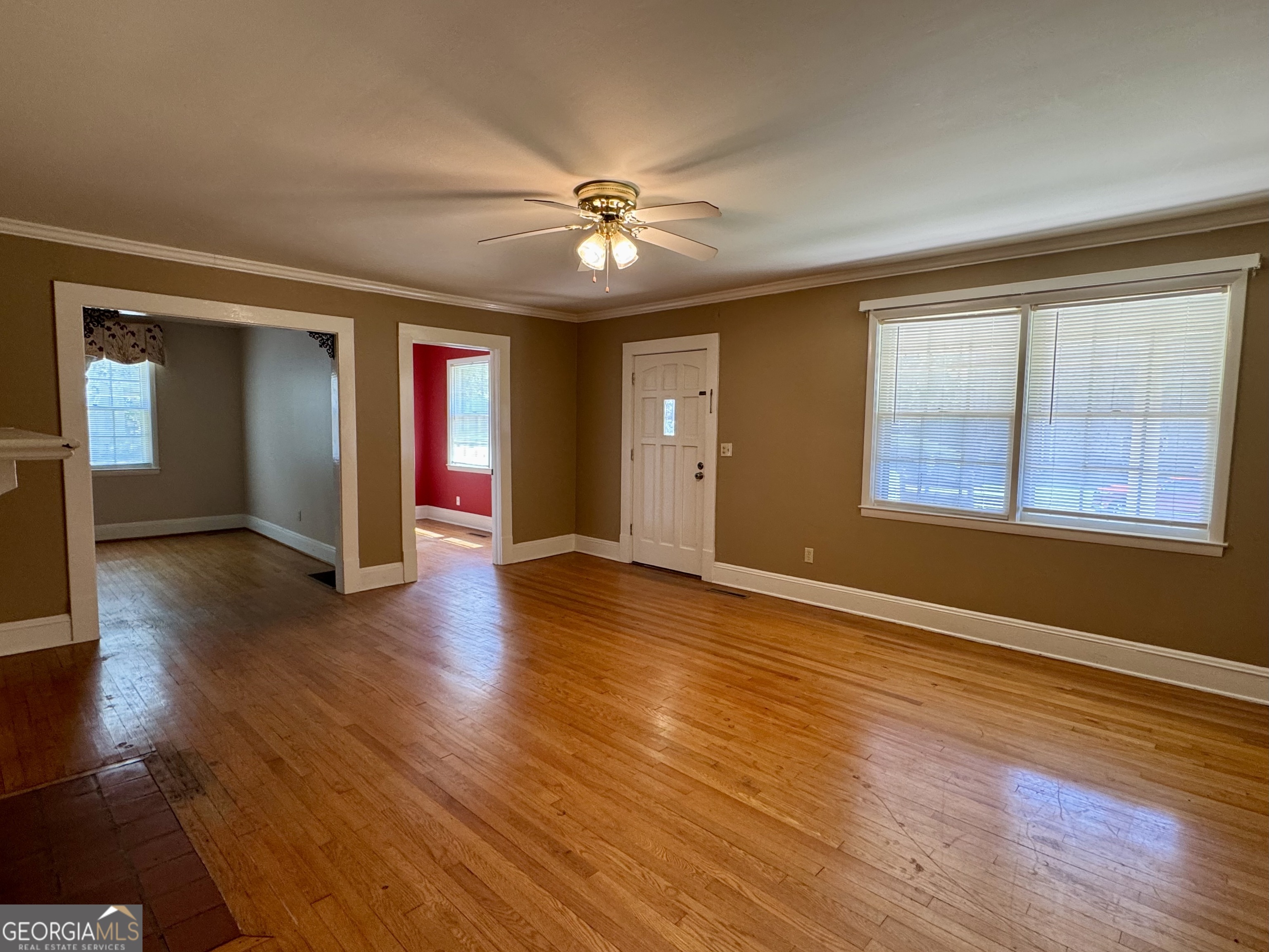 324 North Rhodes Street Union Point, GA 30669 - Photo 12 of 94 a view of an empty room with window and wooden floor