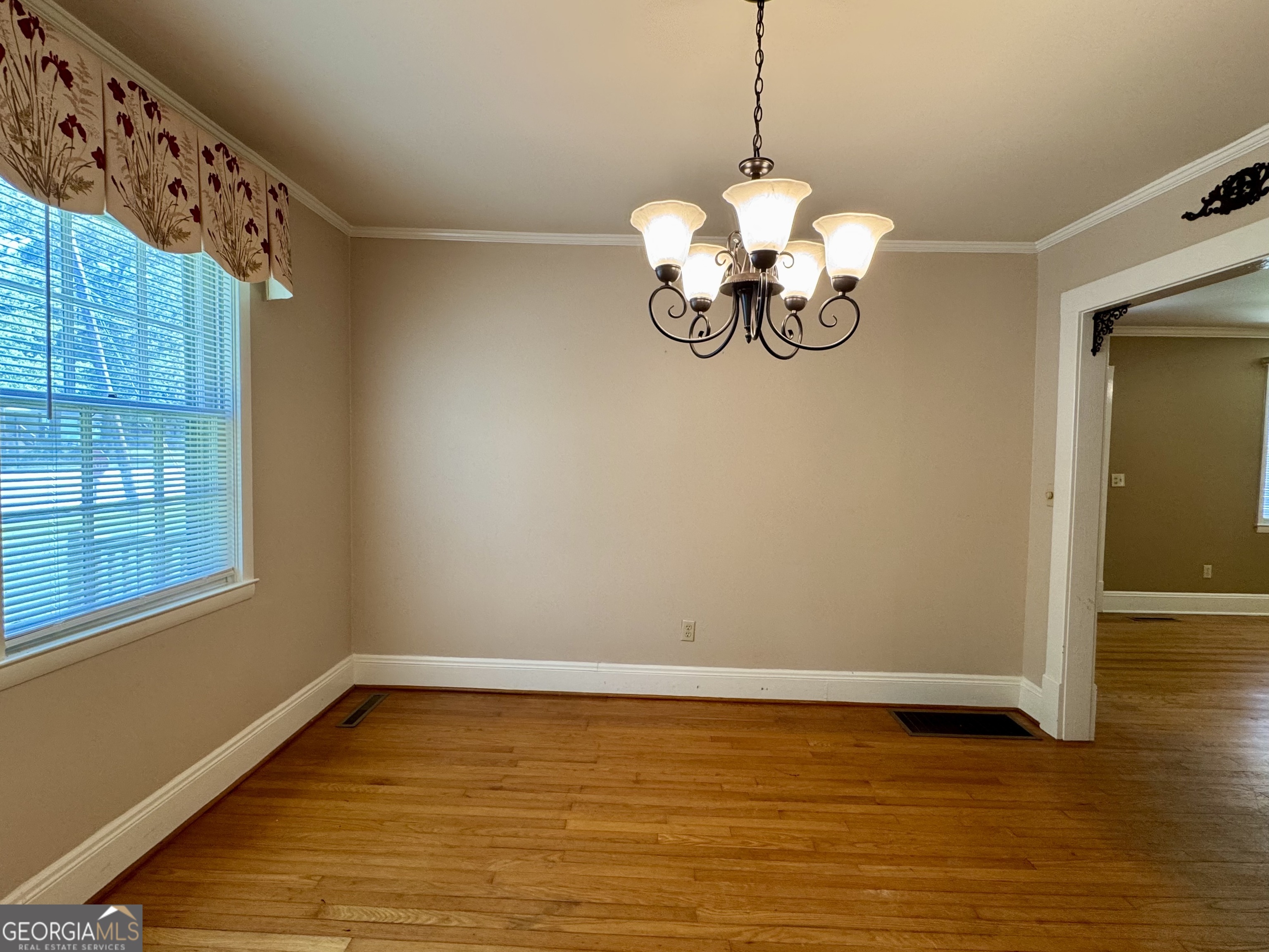 324 North Rhodes Street Union Point, GA 30669 - Photo 19 of 94 a view of a room with wooden floor and chandelier