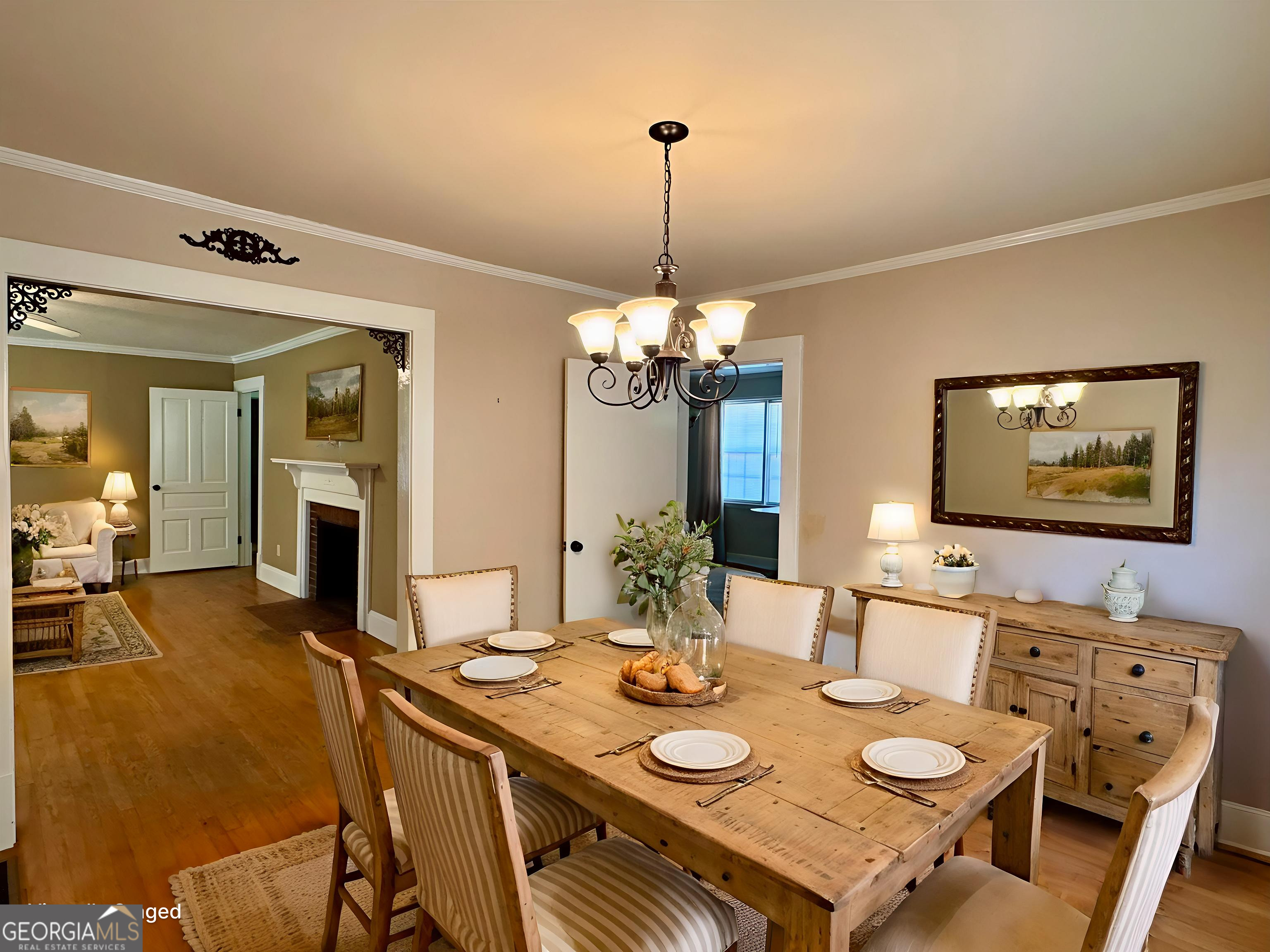 324 North Rhodes Street Union Point, GA 30669 - Photo 22 of 94 a view of a dining room with furniture a chandelier and wooden floor