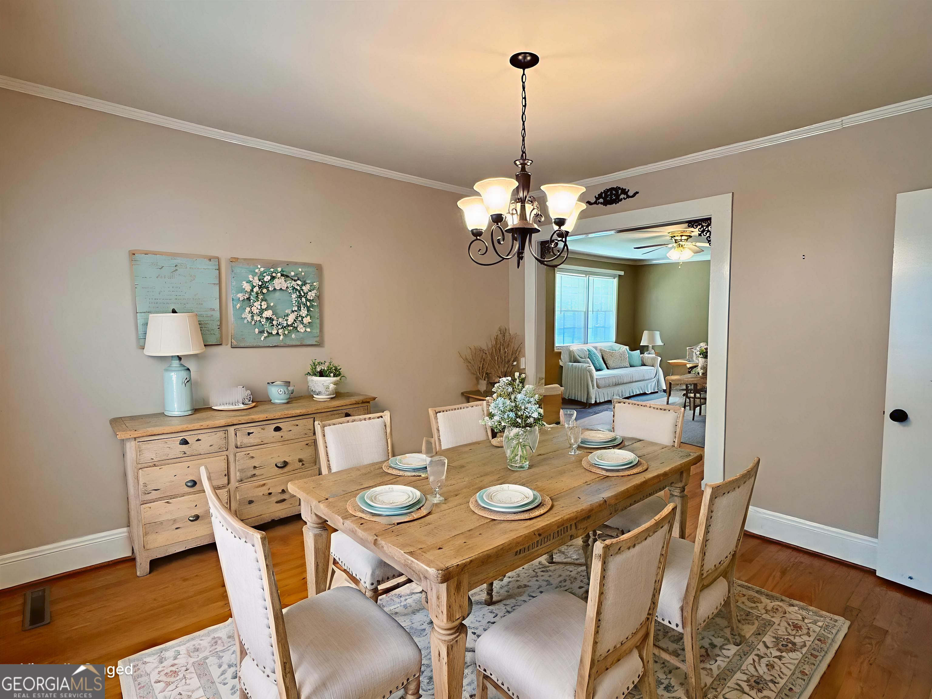 324 North Rhodes Street Union Point, GA 30669 - Photo 24 of 94 a view of a dining room with furniture wooden floor and chandelier