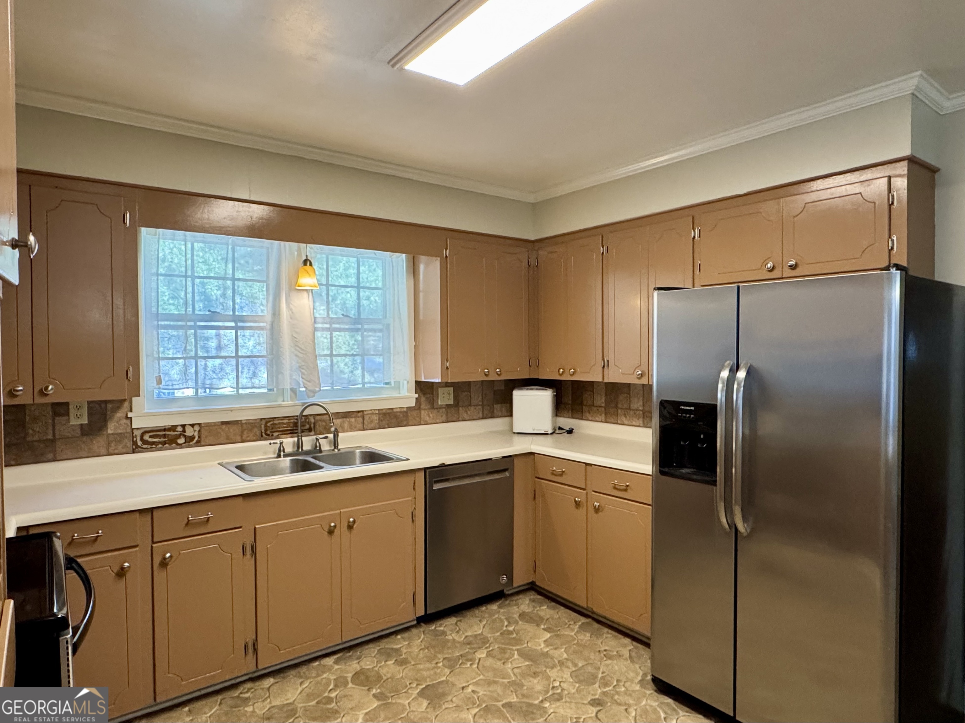 324 North Rhodes Street Union Point, GA 30669 - Photo 29 of 94 a kitchen with a sink refrigerator and window