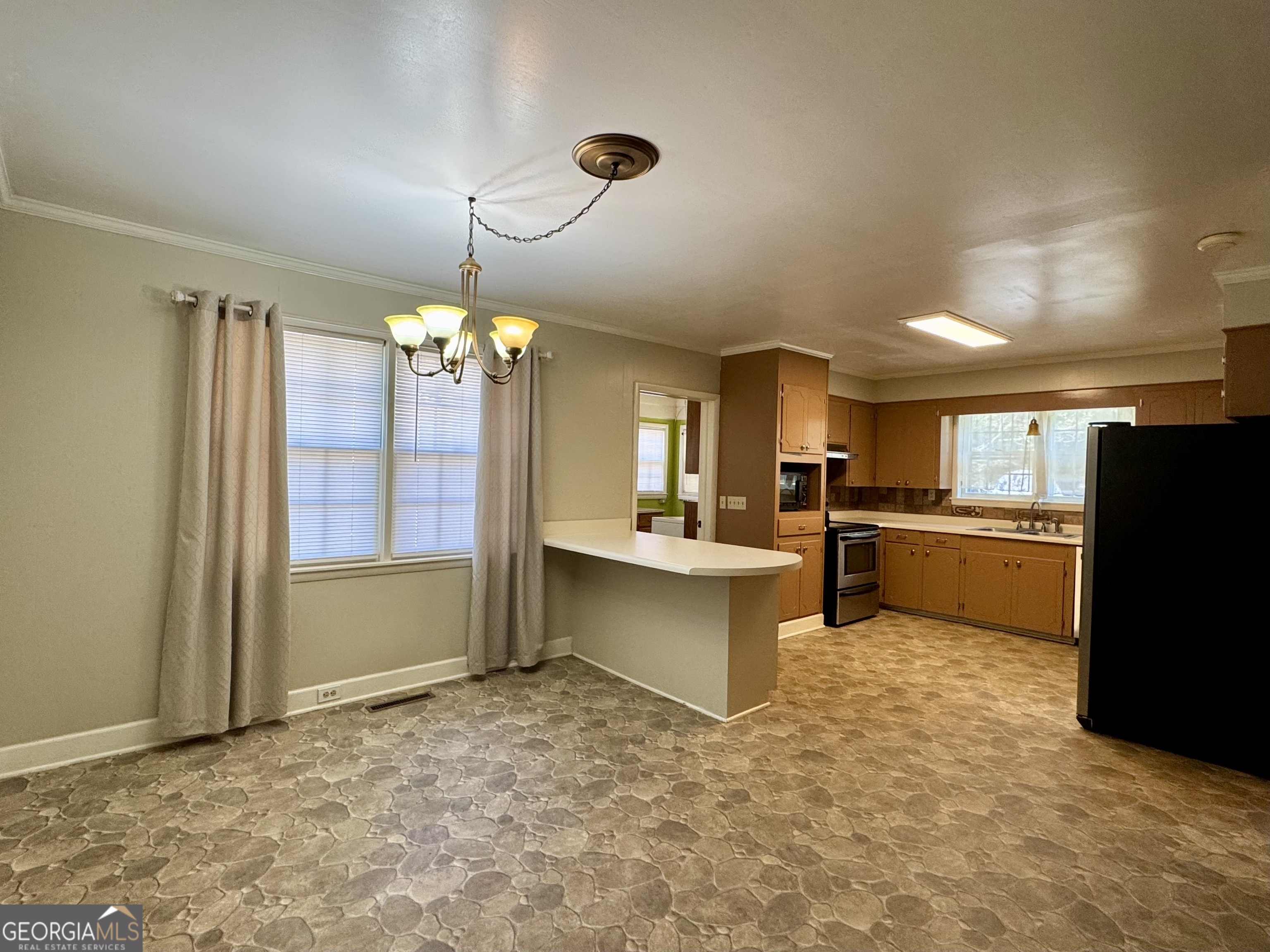 324 North Rhodes Street Union Point, GA 30669 - Photo 32 of 94 a kitchen with granite countertop a refrigerator and a sink