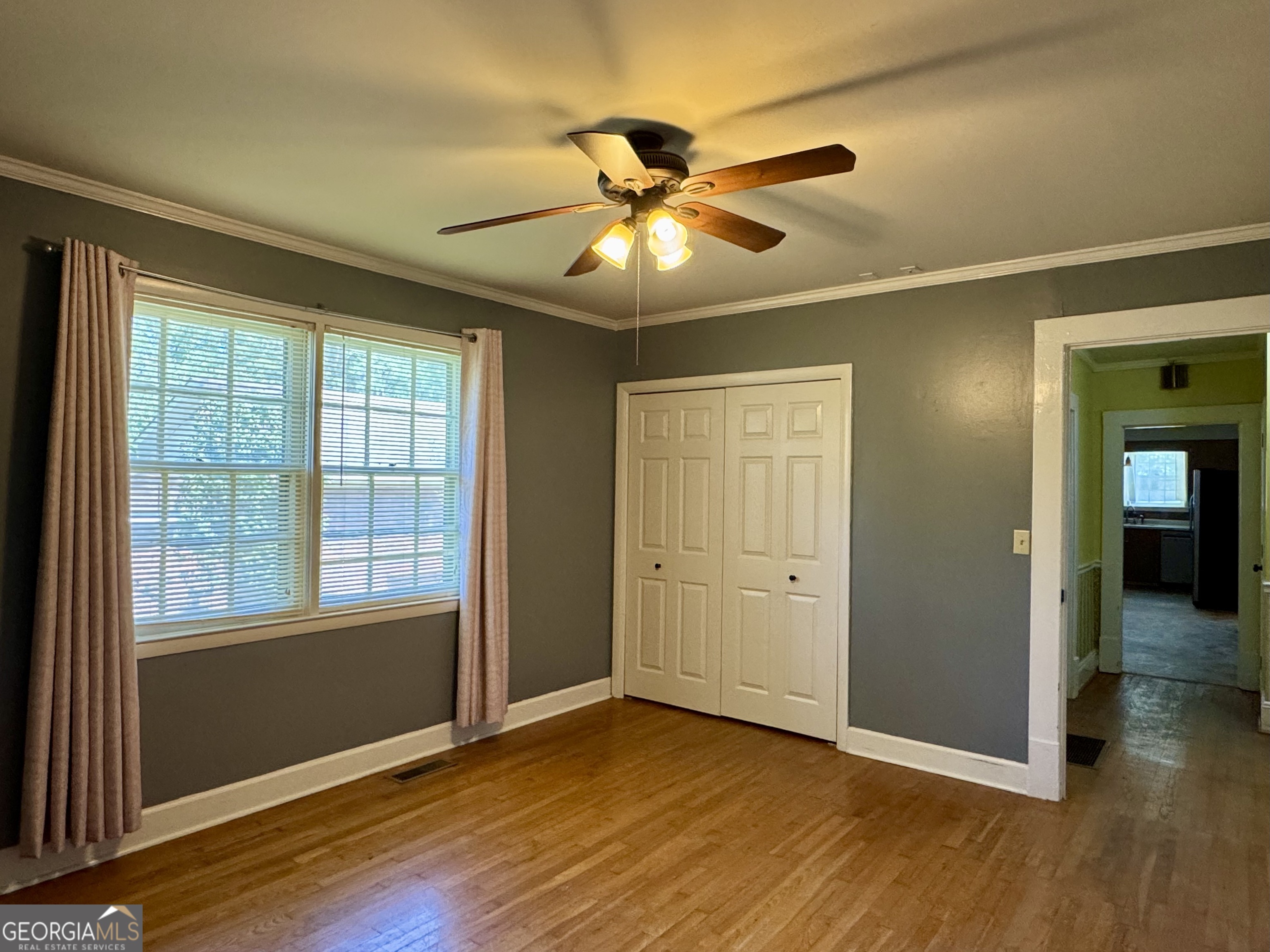 324 North Rhodes Street Union Point, GA 30669 - Photo 43 of 94 an empty room with wooden floor and windows