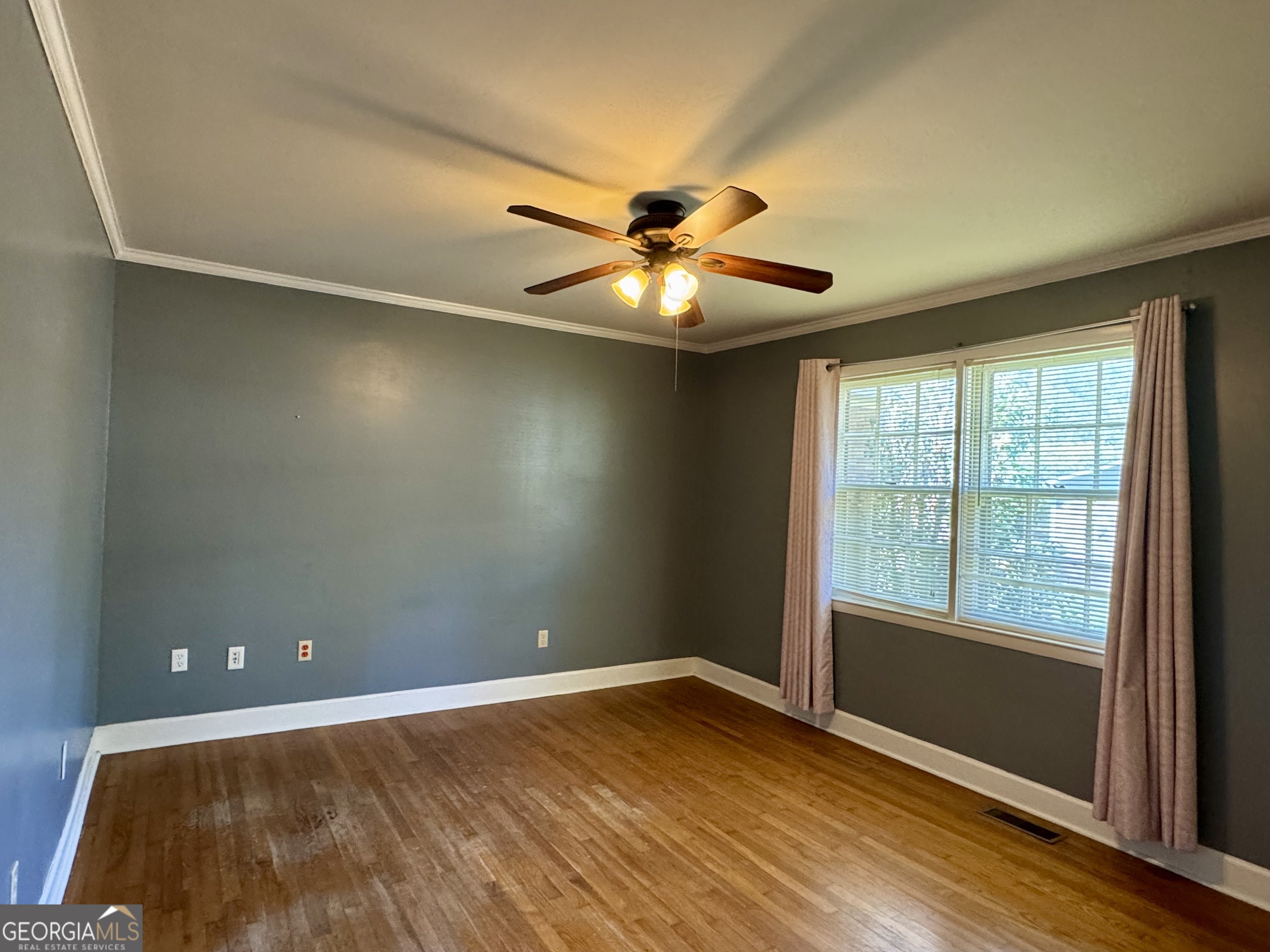 324 North Rhodes Street Union Point, GA 30669 - Photo 44 of 94 an empty room with a window and a fan