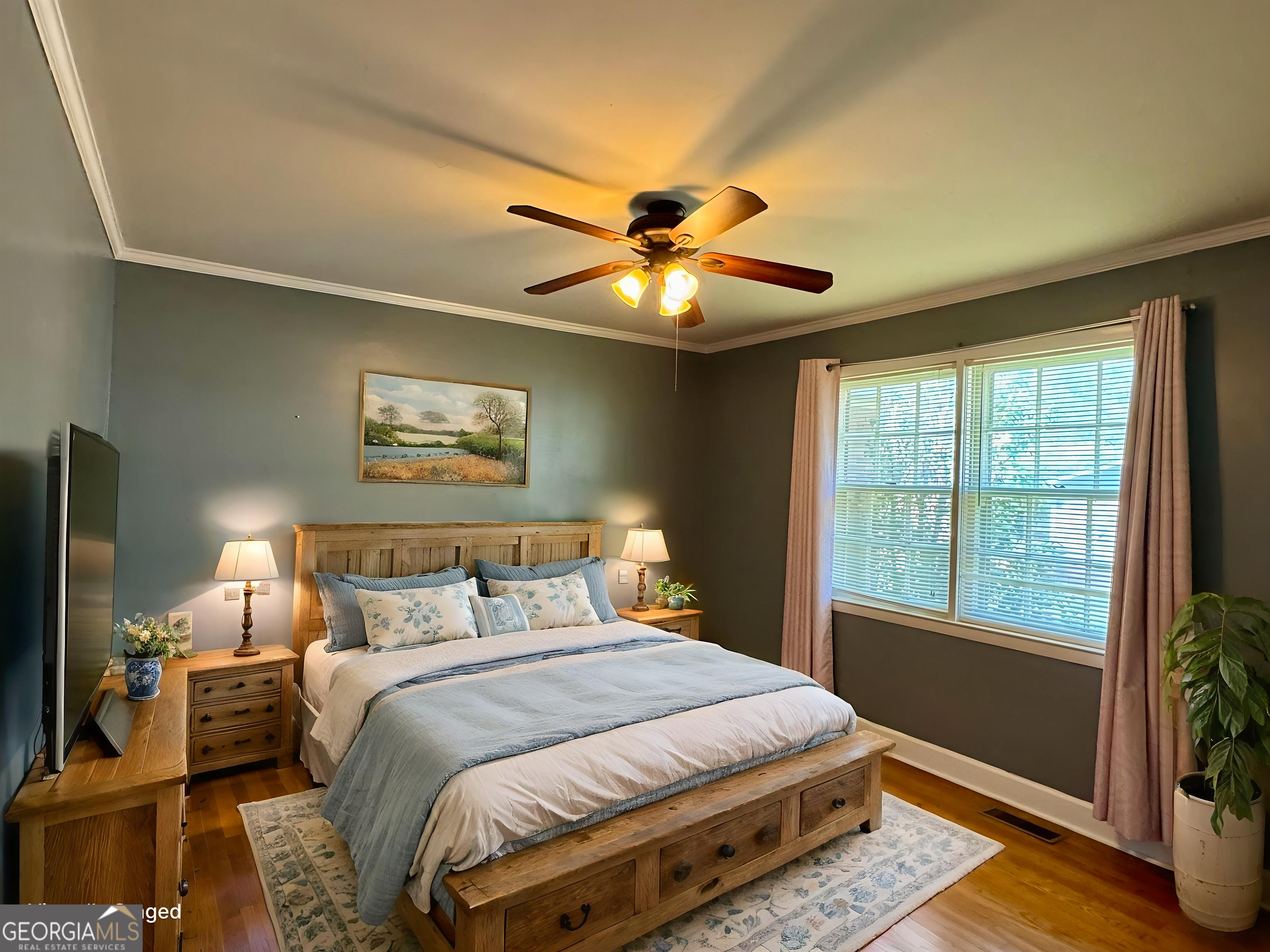 324 North Rhodes Street Union Point, GA 30669 - Photo 45 of 94 a bedroom with a bed and a chandelier