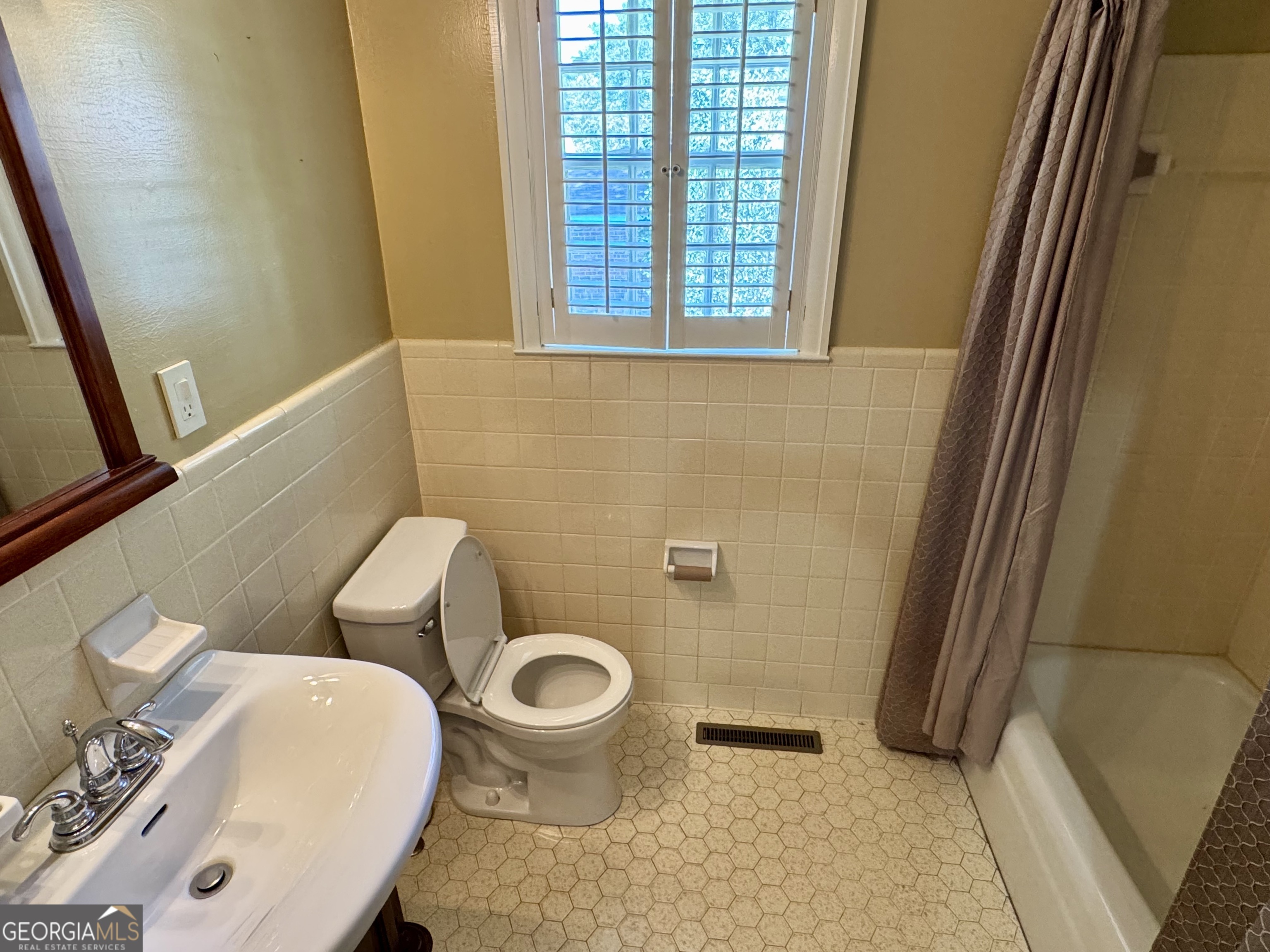 324 North Rhodes Street Union Point, GA 30669 - Photo 49 of 94 a white toilet sitting next to a bathroom sink