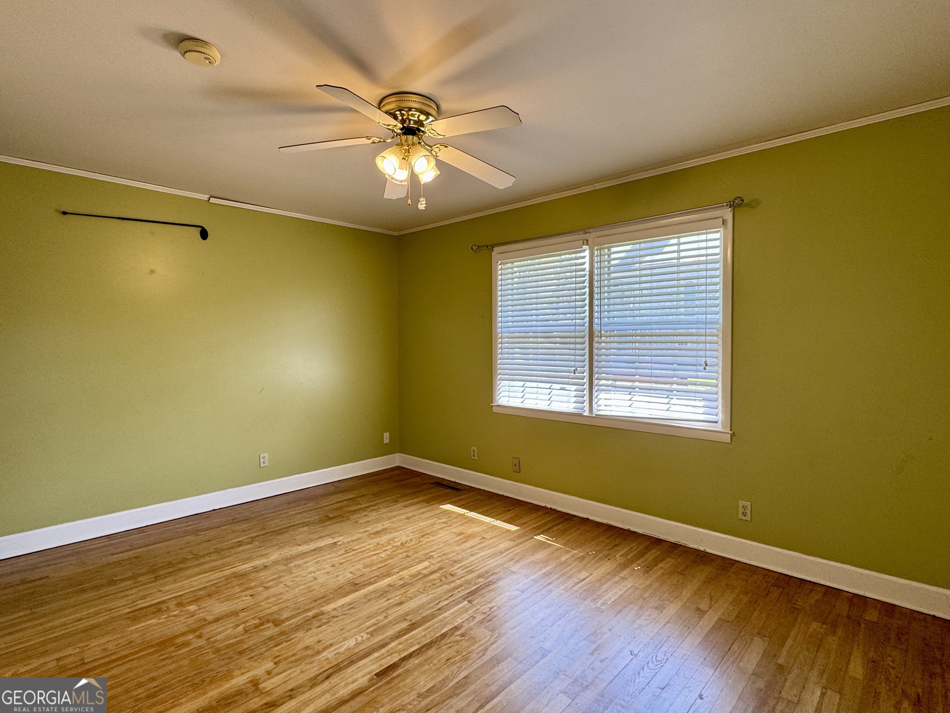 324 North Rhodes Street Union Point, GA 30669 - Photo 50 of 94 a view of an empty room with wooden floor and a window