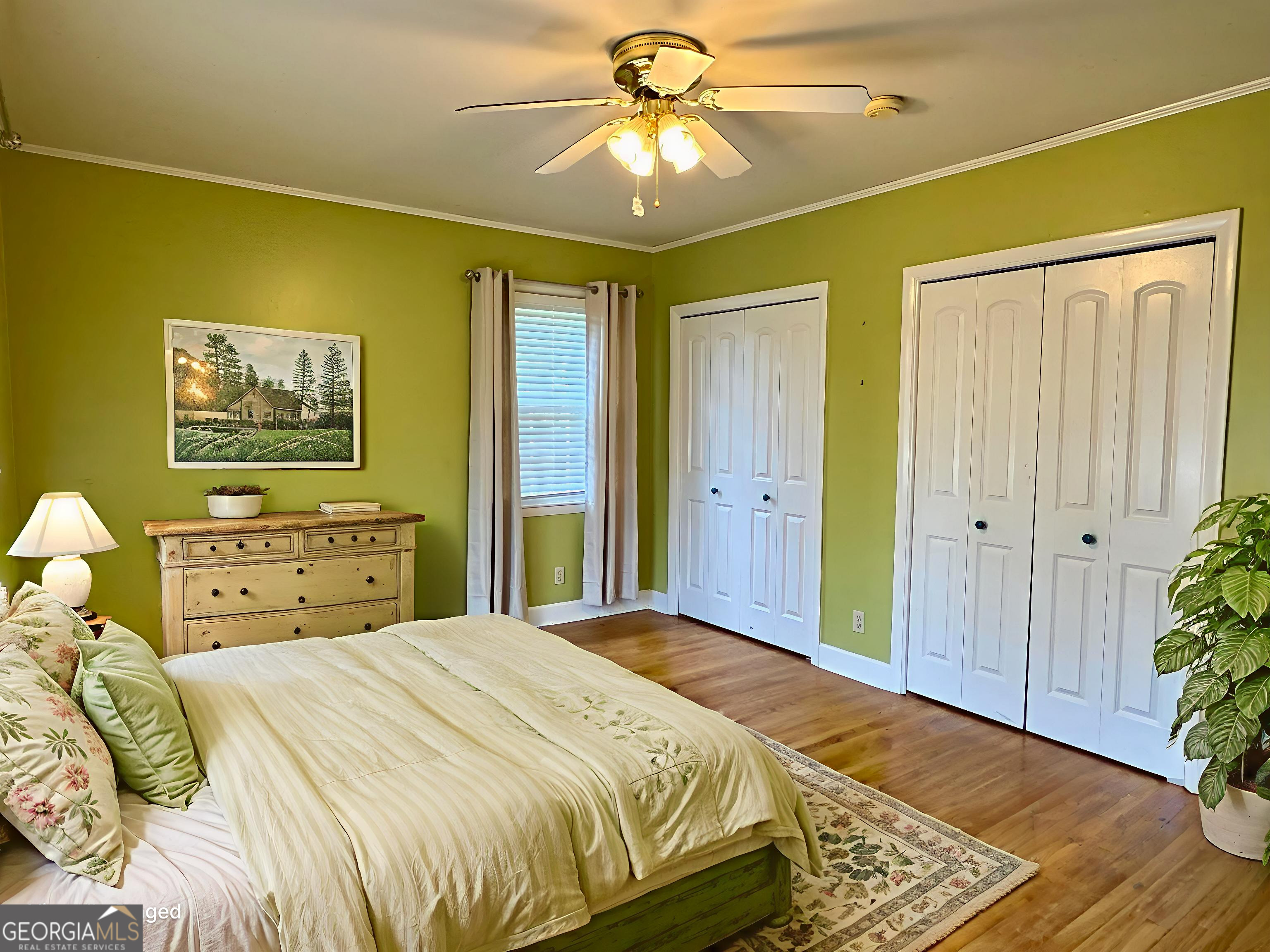 324 North Rhodes Street Union Point, GA 30669 - Photo 53 of 94 a bedroom with a bed and a chandelier