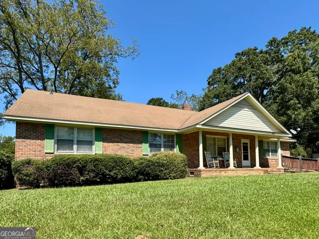 a living room with furniture and a ceiling fan