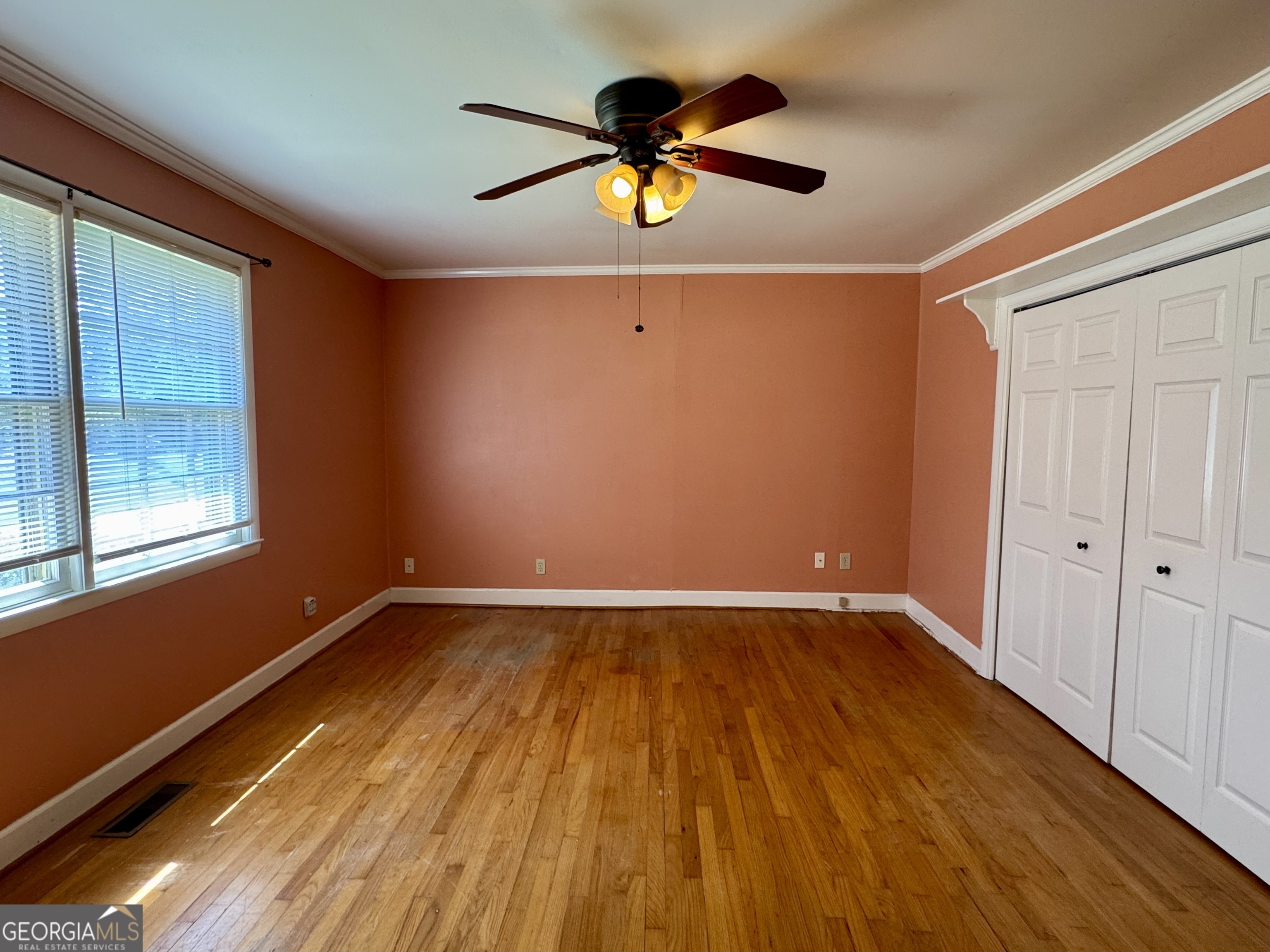 324 North Rhodes Street Union Point, GA 30669 - Photo 63 of 94 a view of empty room with wooden floor and fan