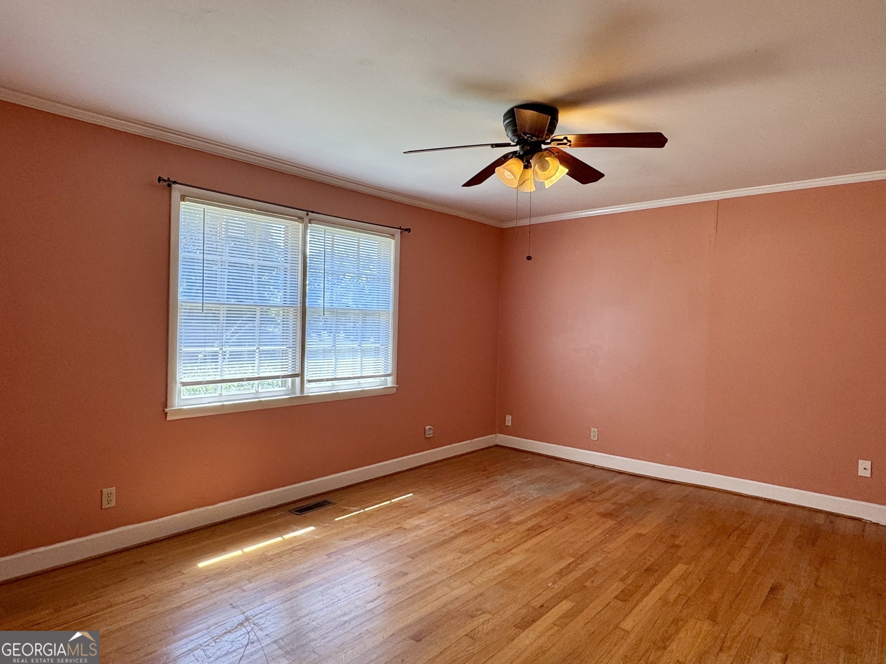 324 North Rhodes Street Union Point, GA 30669 - Photo 67 of 94 a view of an empty room with wooden floor and a window