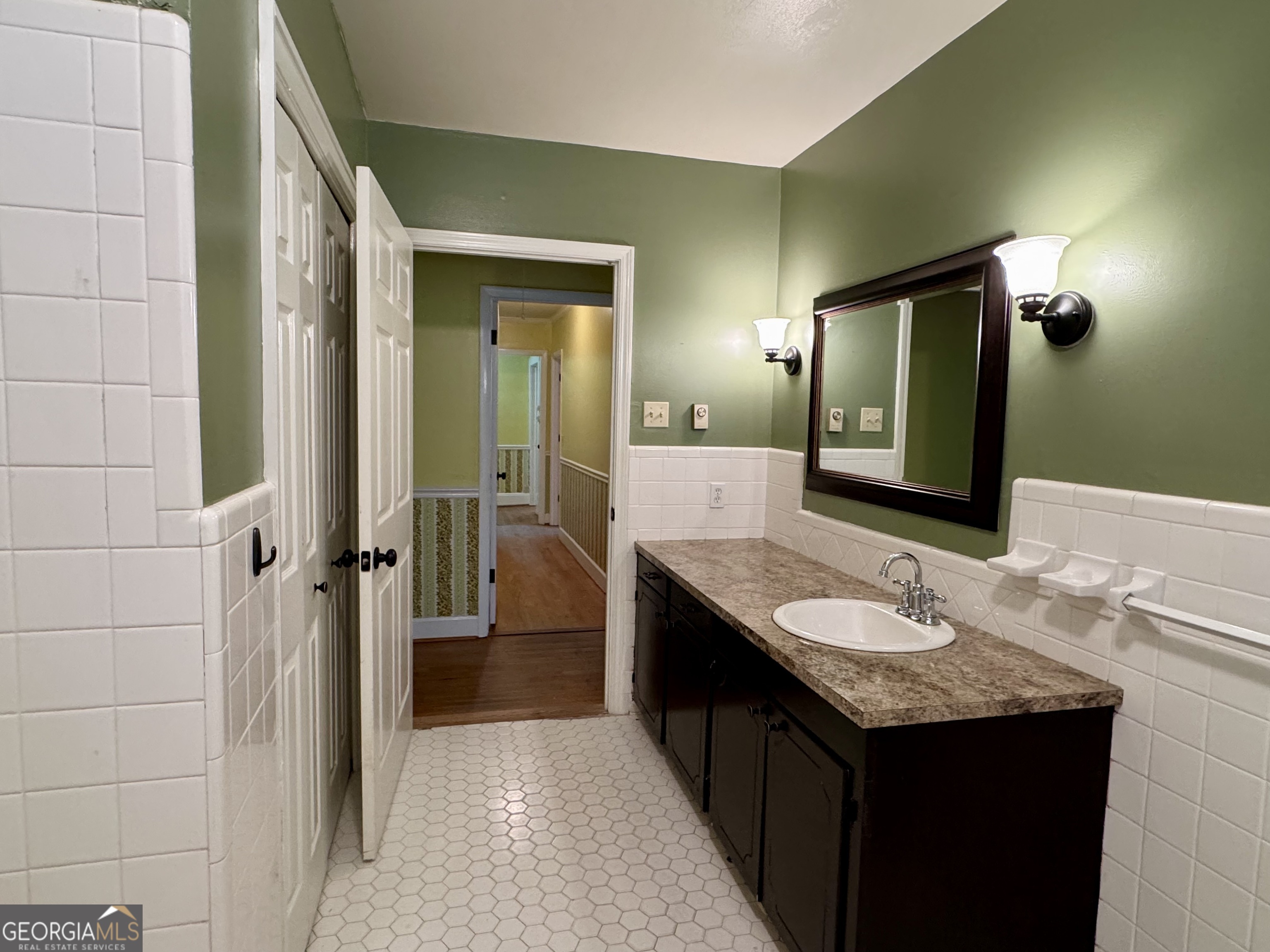 324 North Rhodes Street Union Point, GA 30669 - Photo 69 of 94 a bathroom with a granite countertop sink and a mirror