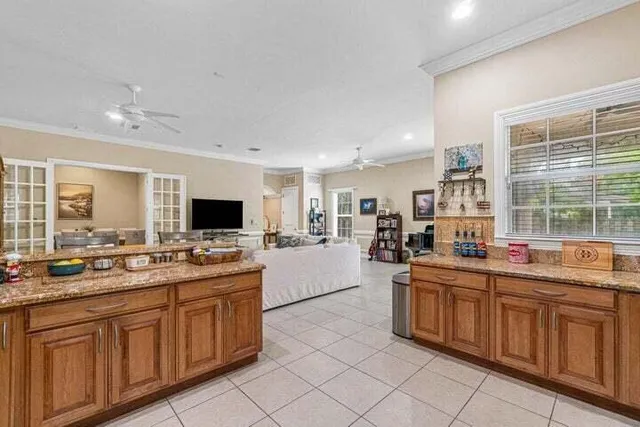 a large kitchen with a large counter top appliances and cabinets