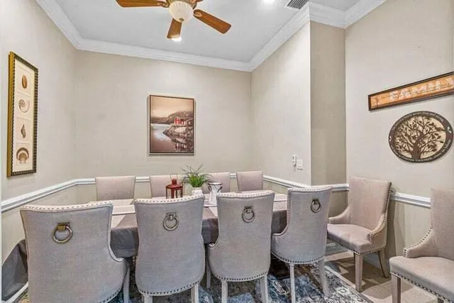 a dining room with furniture and a chandelier