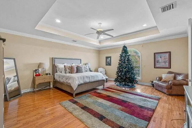 a bedroom with a bed and a chandelier