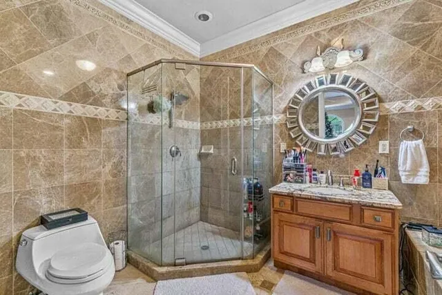 a bathroom with a sink mirror toilet and shower