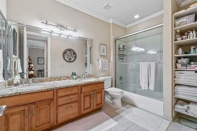 a spacious bathroom with a granite countertop sink mirror toilet and shower