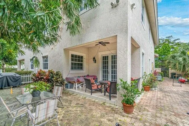 a view of a house with backyard and sitting area