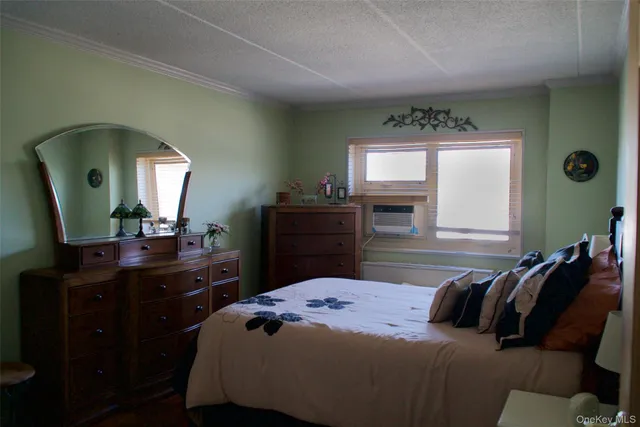 a bedroom with a bed and a mirror on dresser
