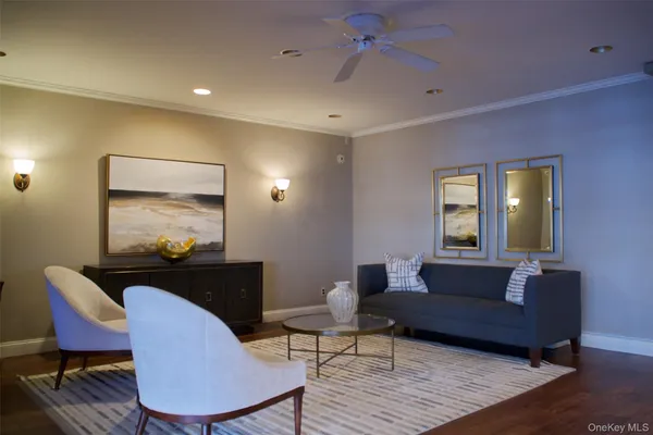a living room with furniture and a potted plant