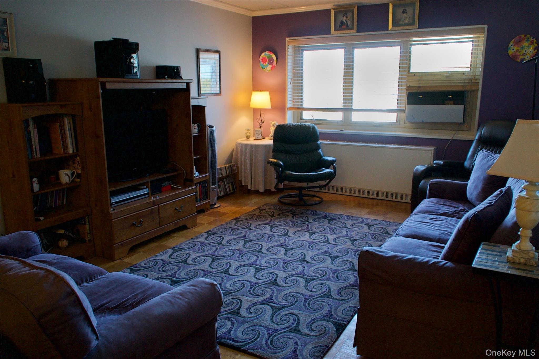 470 Halstead Avenue, Unit 6V Harrison, NY 10528 - Photo 4 of 20 a living room with furniture a flat screen tv and a window