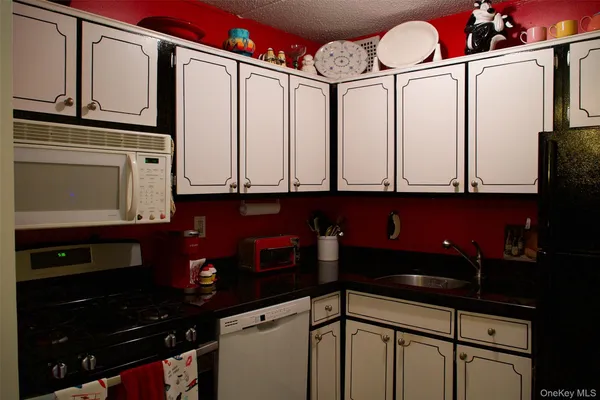 a kitchen with stainless steel appliances a cabinets and a stove top oven