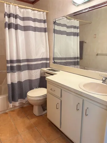 a bathroom with a toilet a sink and a mirror