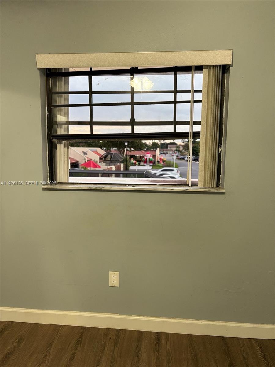 6460 Northwest 192nd Terrace, Unit 6460 Hialeah, FL 33015 - Photo 17 of 42 a view of a large room with wooden floor and windows