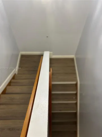 a view of a workspace with furniture and wooden floor