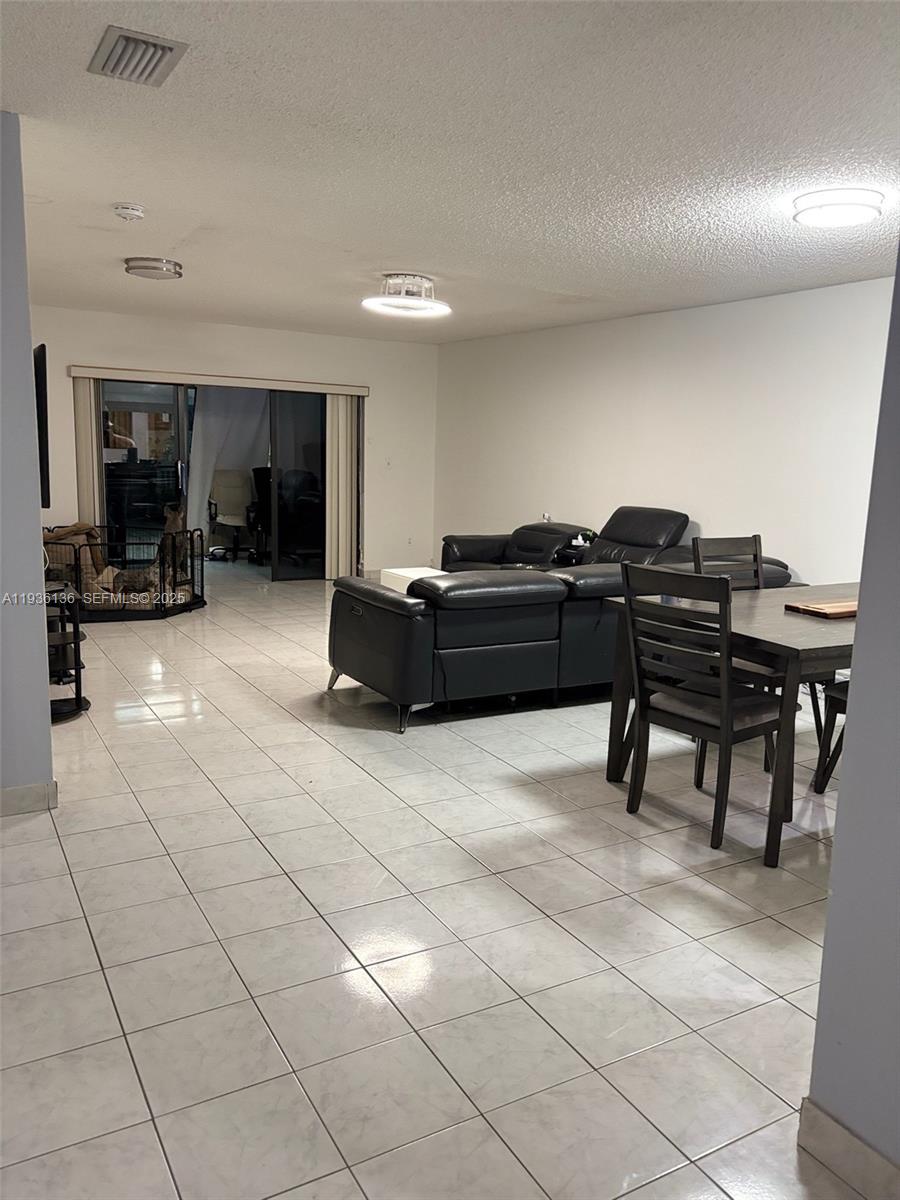 6460 Northwest 192nd Terrace, Unit 6460 Hialeah, FL 33015 - Photo 22 of 42 a living room with furniture and a piano