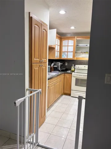 a kitchen with a refrigerator and cabinets