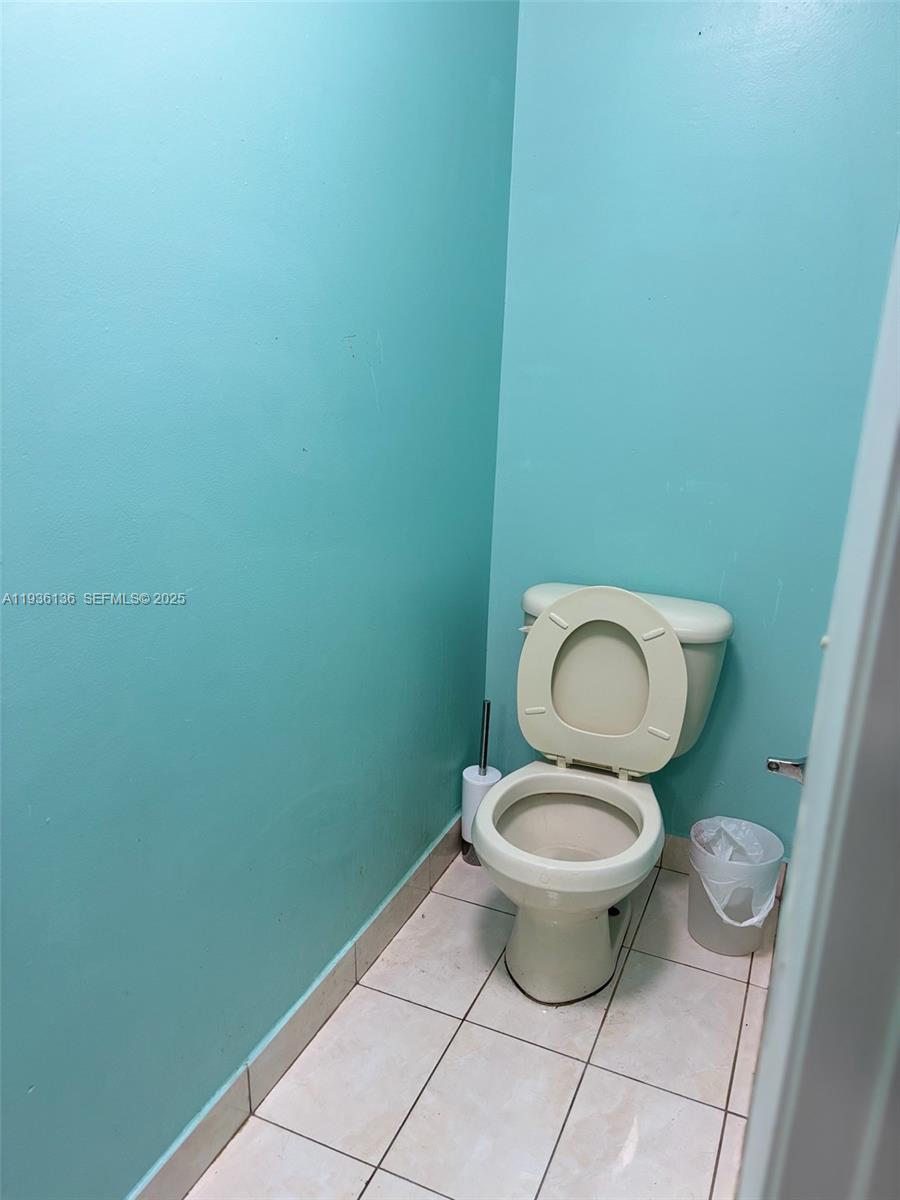 6460 Northwest 192nd Terrace, Unit 6460 Hialeah, FL 33015 - Photo 31 of 42 a white toilet sitting in a bathroom