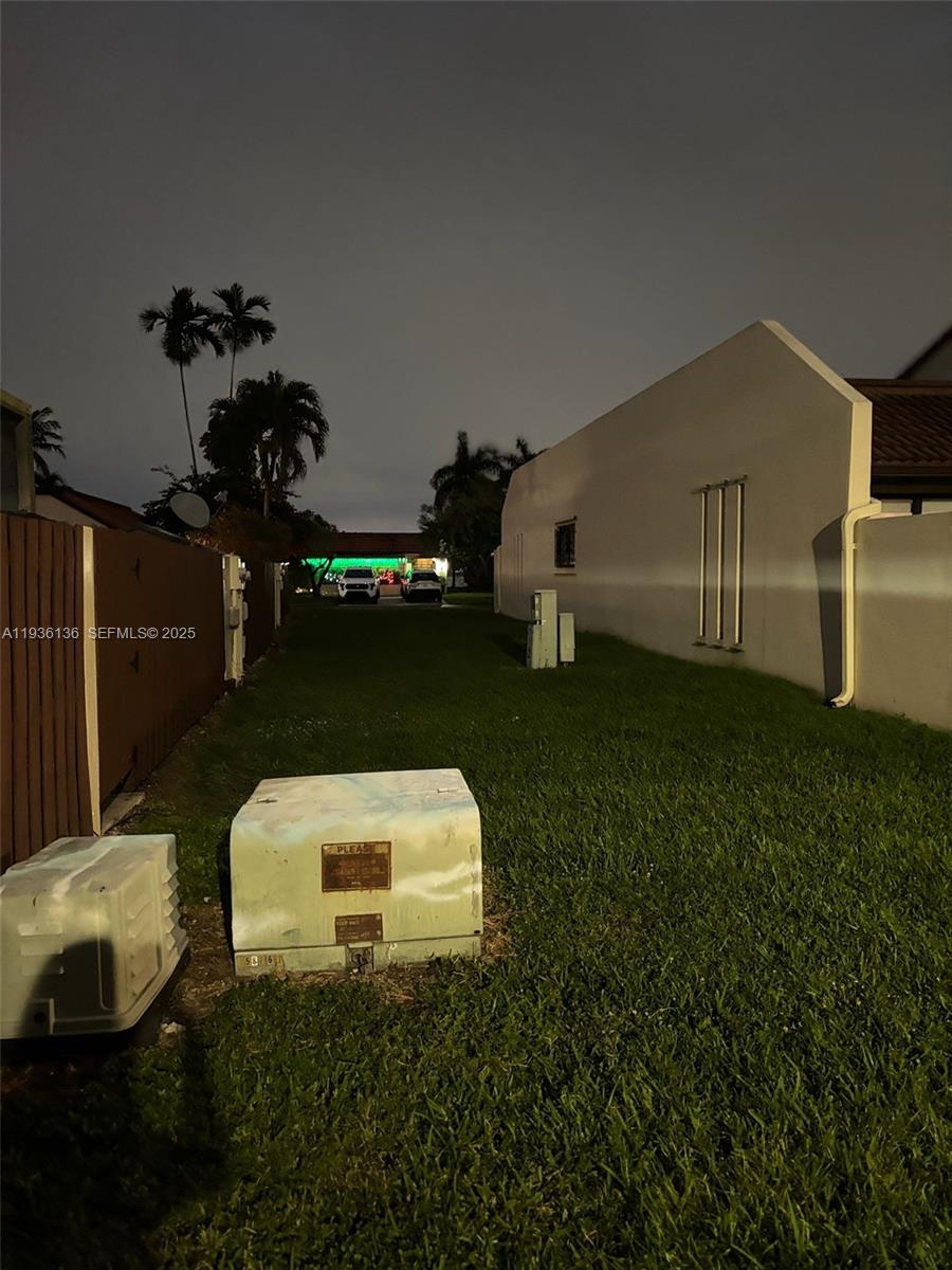 6460 Northwest 192nd Terrace, Unit 6460 Hialeah, FL 33015 - Photo 41 of 42 a backyard of a house with table and chairs