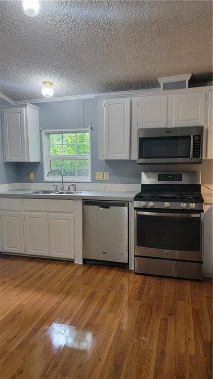 174 Luther Circle Villa Rica, GA 30180 - Photo 6 of 32 a kitchen with granite countertop a stove a sink and a microwave