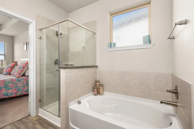 a bathroom with a tub and a shower