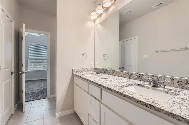 a view of an empty room with closet and a window