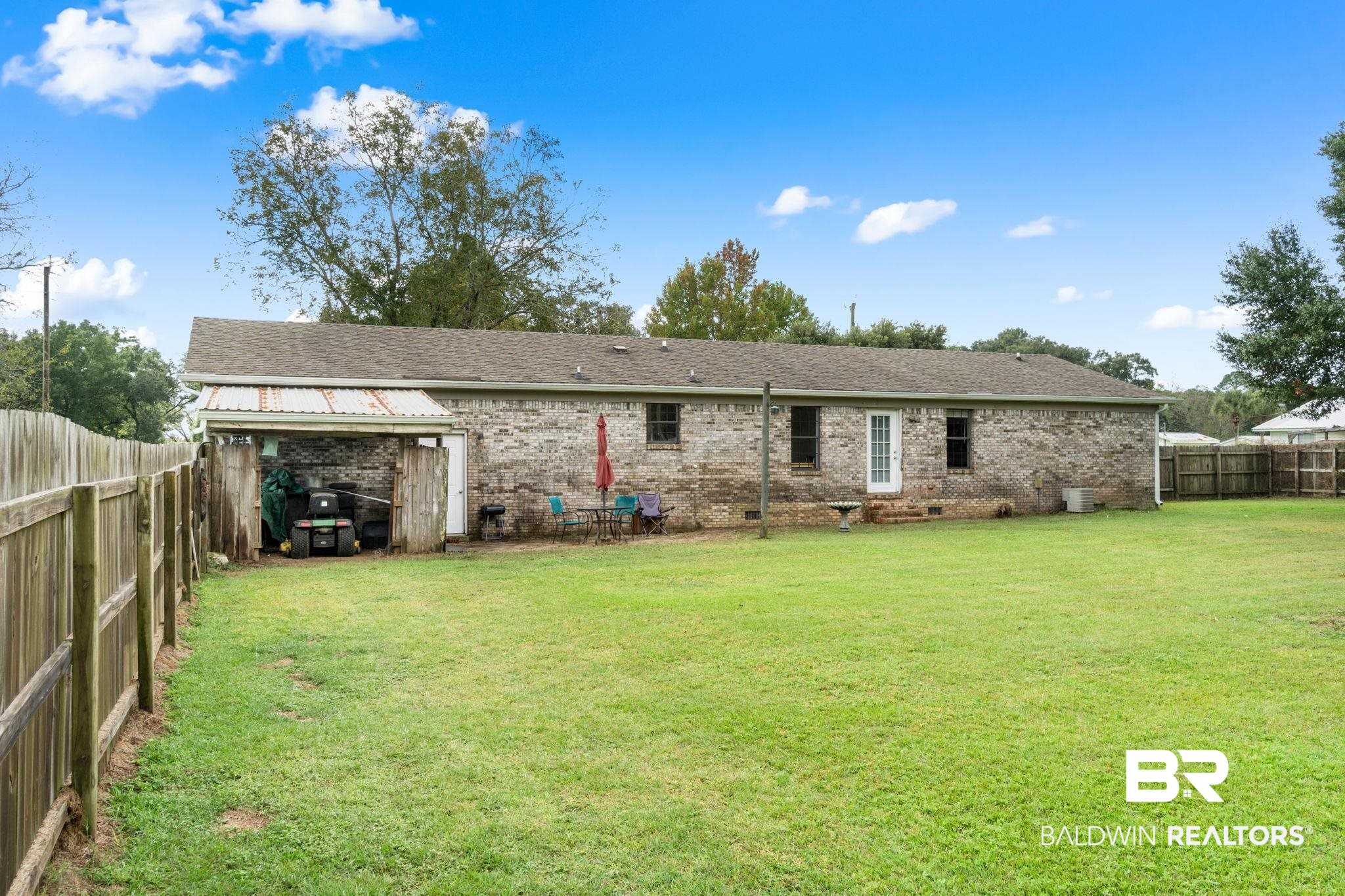 33135 Collier Road Lillian, AL 36549 - Photo 26 of 30 Rear view of house featuring a fenced backyard and brick siding