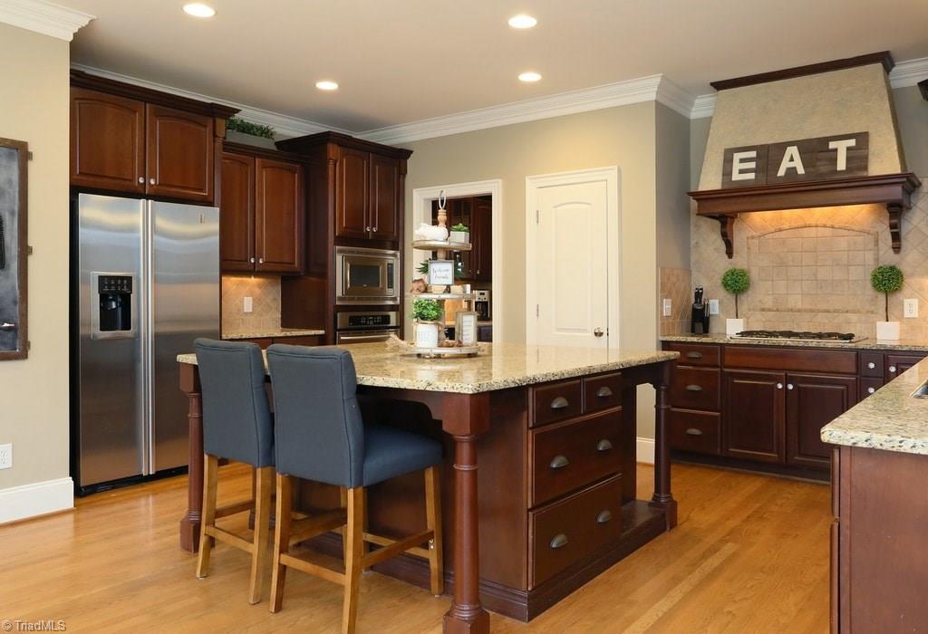 8403 Oakchester Court Oak Ridge, NC 27310 - Photo 6 of 18 A kitchen is always the soul of a home, and this one with its extra large island and open arches is a wonderful place to entertain family and friends!