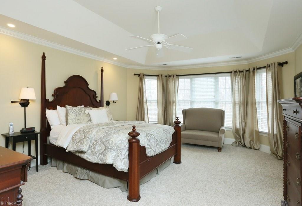 8403 Oakchester Court Oak Ridge, NC 27310 - Photo 10 of 18 The master bedroom is bright with a large window that overlooks the wooded back yard and pool.