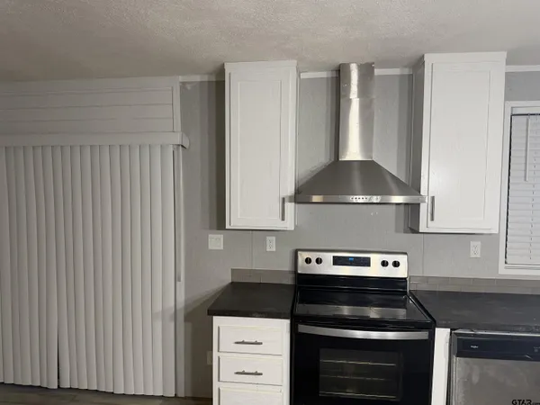 a bathroom with a granite countertop toilet and a sink