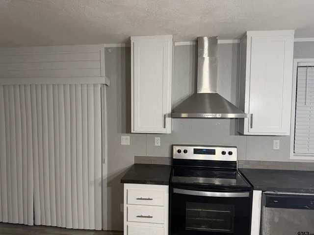 a bathroom with a granite countertop toilet and a sink