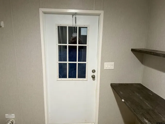 a view of a bedroom with wooden floor and closet