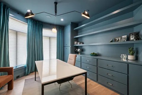 a living room with furniture and a floor to ceiling window