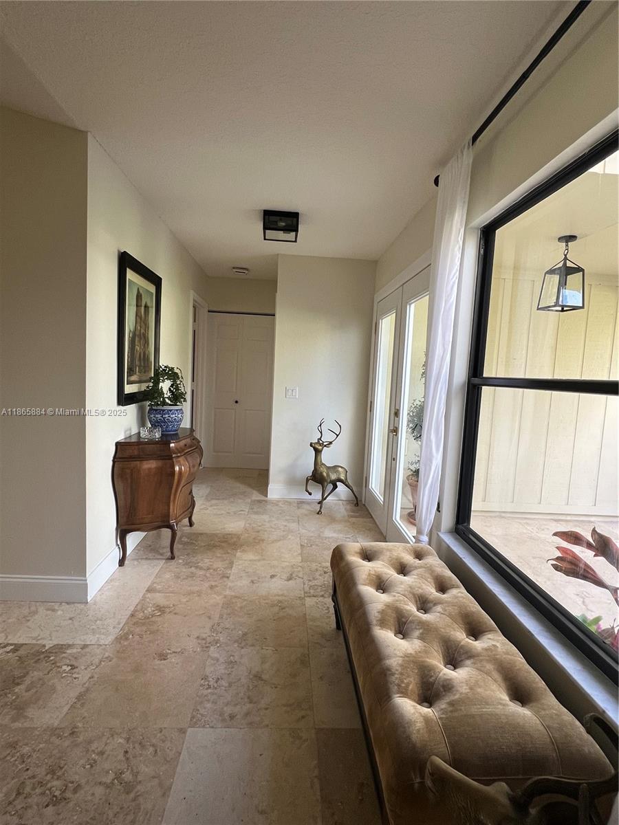 6198 Brandon Street, Unit 6198 Palm Beach Gardens, FL 33418 - Photo 15 of 26 a living room with furniture and a large window