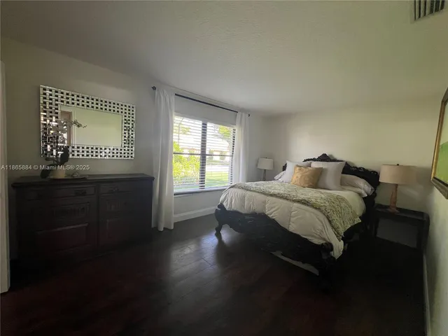 a very nice looking dining room with a chandelier furniture and a flat screen tv