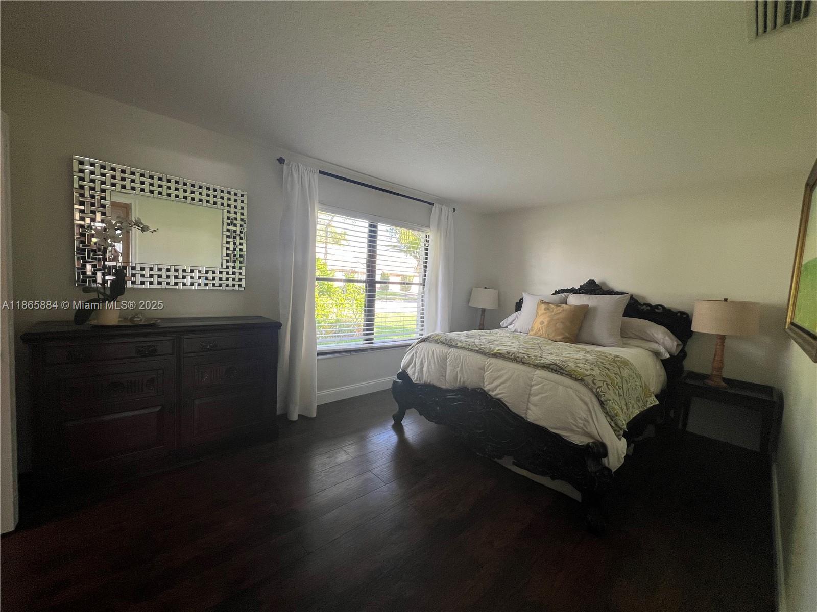 6198 Brandon Street, Unit 6198 Palm Beach Gardens, FL 33418 - Photo 22 of 26 a bedroom with a bed and a window