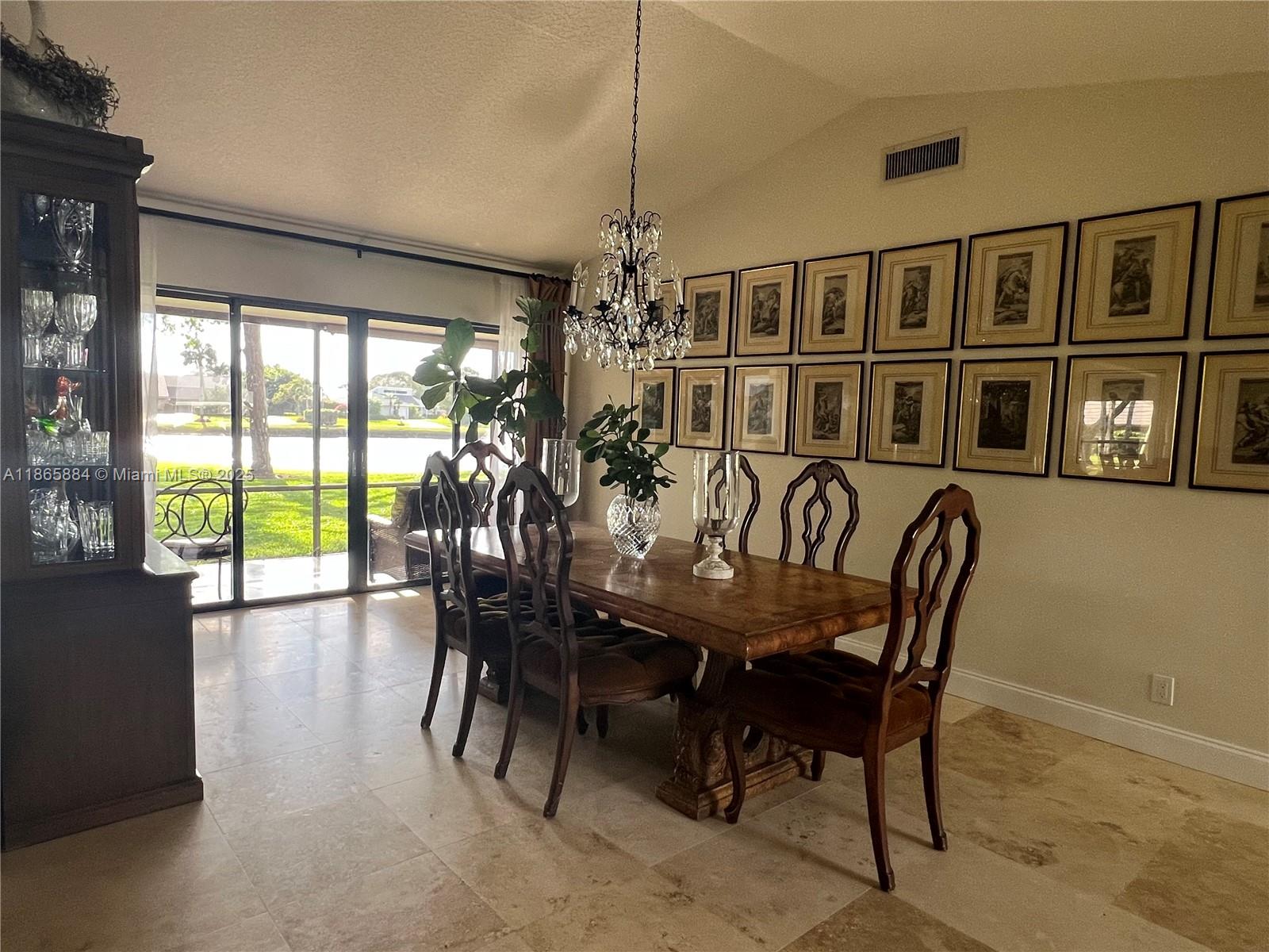 6198 Brandon Street, Unit 6198 Palm Beach Gardens, FL 33418 - Photo 25 of 26 a view of a dining room with furniture window and outside view